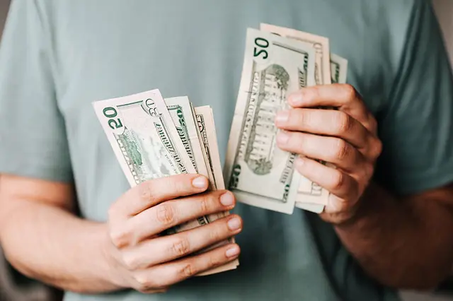 Cash payment being handed over for an estate buyout